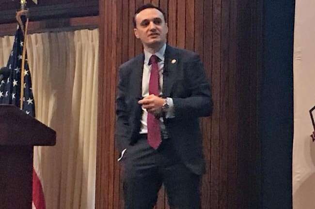 Nicolas speaking at formal event